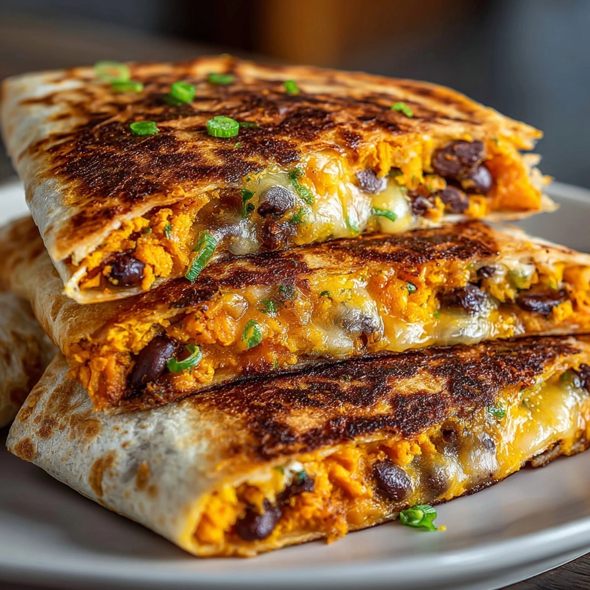 Easy Microwave Sweet Potato and Black Bean Quesadilla, warm tortilla oozing melted cheese.