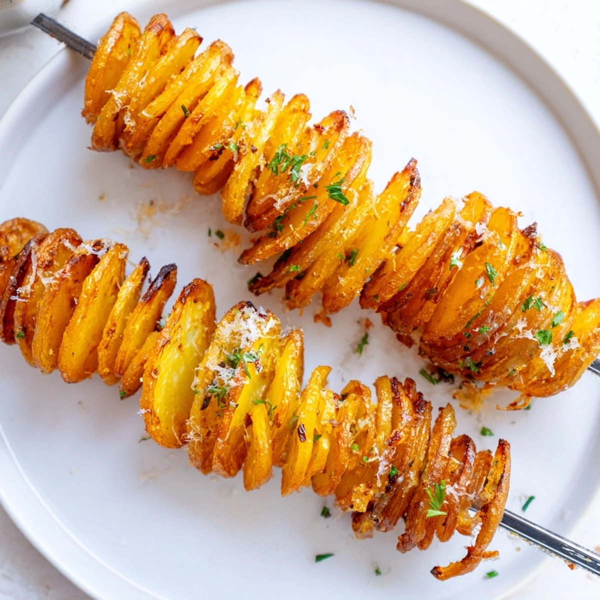 Crispy Air-Fryer Tornado Potatoes served on skewers, seasoned with garlic and paprika.  