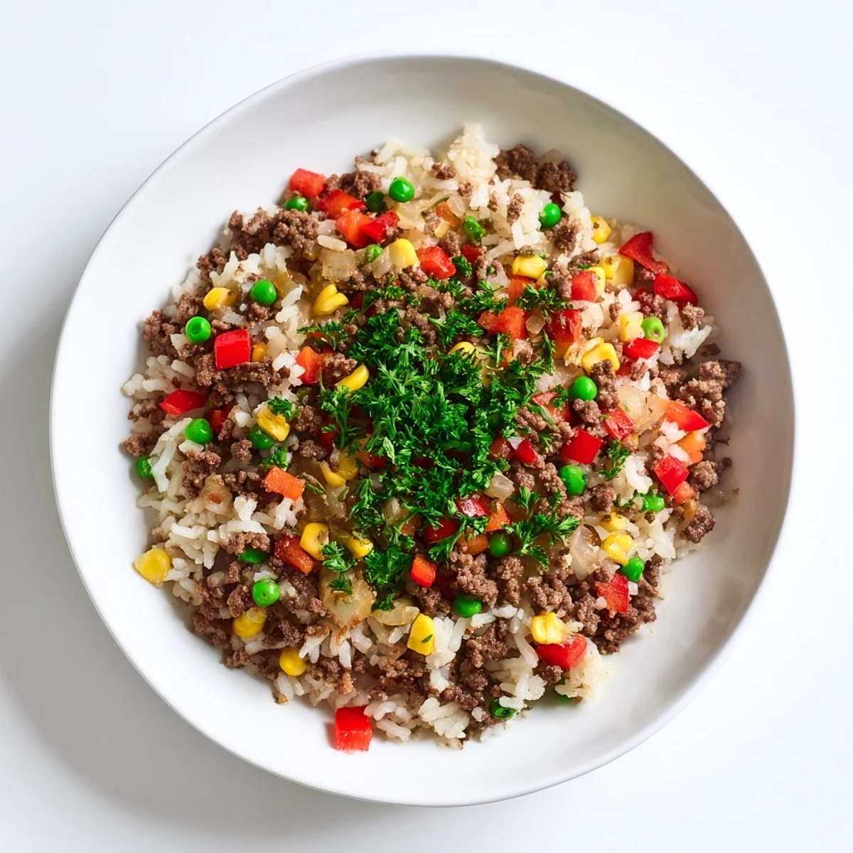 Enjoy a delicious plate of Ground Beef Skillet with Veggies & Rice, smelling of spices and perfectly cooked.