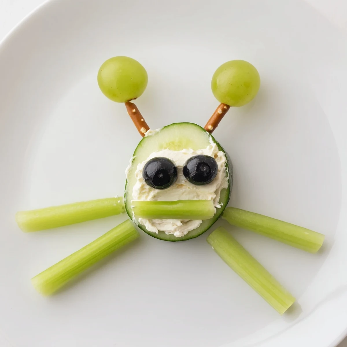 Vibrant Little Green Men Alien Snack Attack plate featuring goofy, smiling cucumber alien faces.