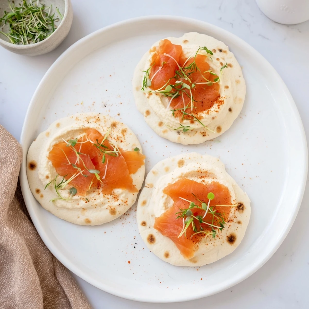 Enjoy a refreshing The Driftwood Beach, with tender fish and dill on crunchy crackers, a perfect appetizer.