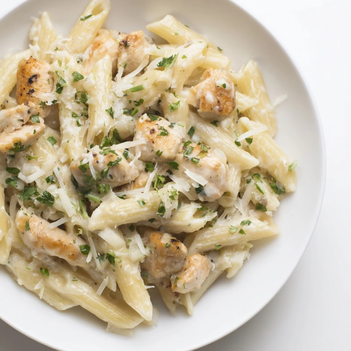 Quick Garlic Parmesan Chicken Pasta simmering in a pan; creamy sauce coats perfectly cooked pasta and chicken.