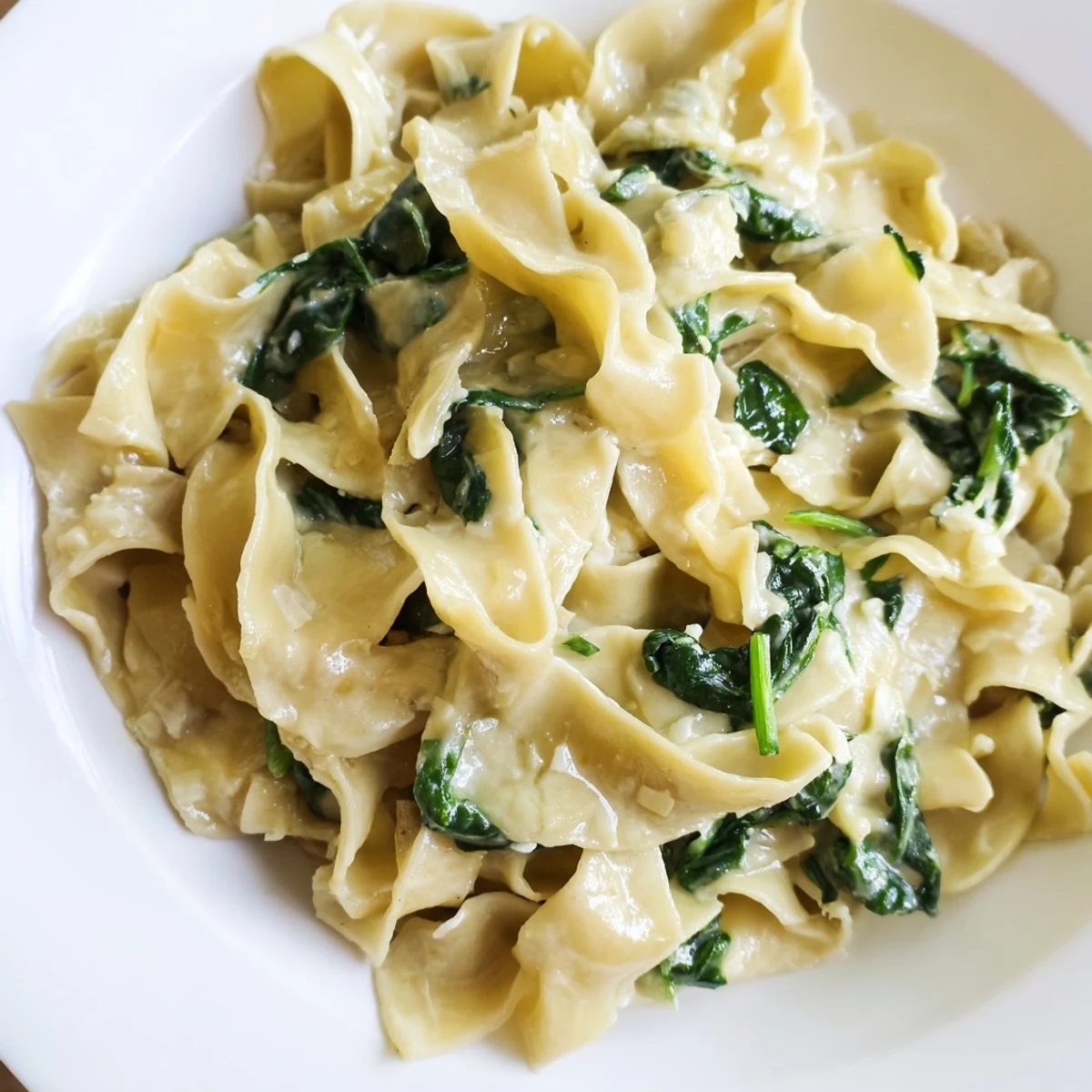 Creamy Spinach Garlic Noodles twirl in a velvety Parmesan sauce, with sautéed spinach leaves mingling throughout the tender egg noodles.