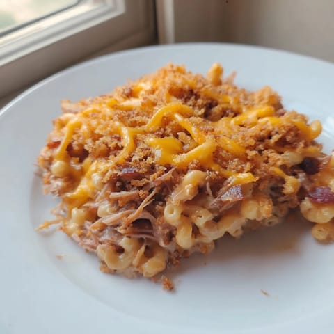 Decadent BBQ Pulled Pork Macaroni Bake, golden and bubbling, perfect for family dinners.  