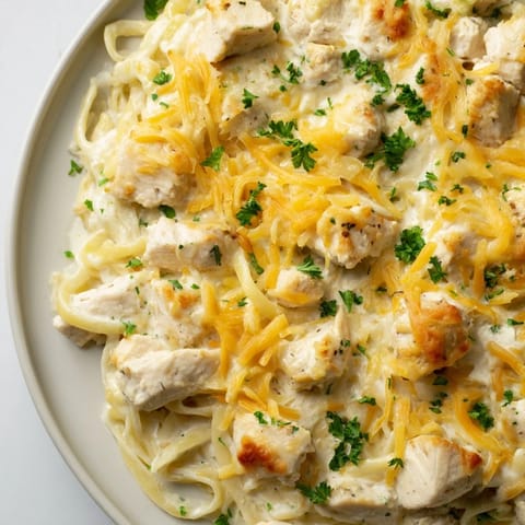 This Chicken Fettuccine Alfredo bake has tender chicken in creamy Alfredo sauce, perfect for dinner.