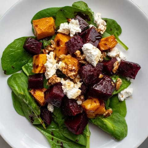 Warm, roasted butternut squash and beet salad with a flavorful balsamic vinaigrette, ready to serve.