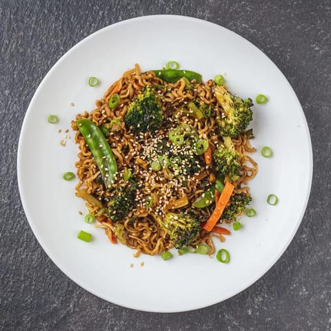 This quick Ramen Noodle Stir-Fry Remix shows perfectly cooked noodles with toasted sesame seeds on top.