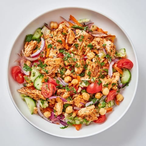 Freshly tossed Chicken Salad featuring crisp romaine, juicy tomatoes, and a tangy lemon dressing.