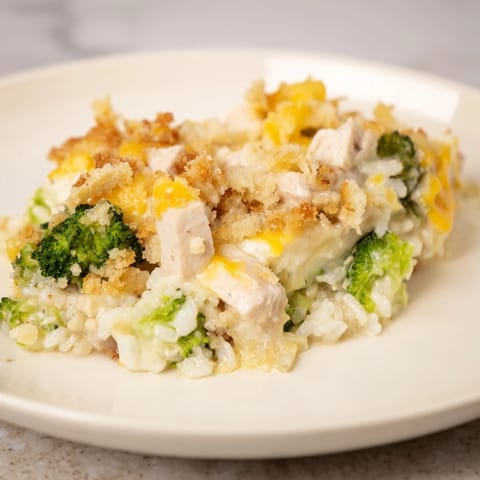 A close-up view of creamy Chicken & Broccoli Rice Casserole, with melted cheese and tender chicken.