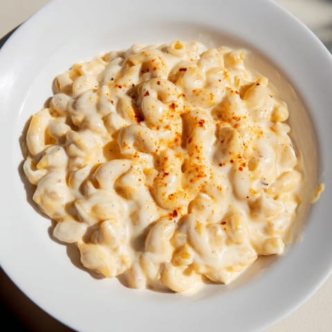 A close-up of a bubbling pot of One-Pot Butternut Squash Mac & Cheese, ready to serve.