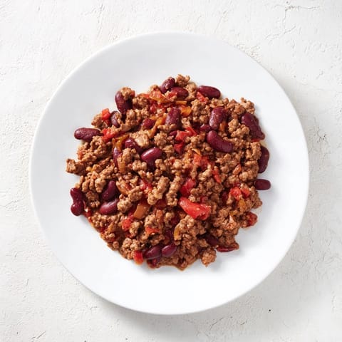 A rich, flavorful close-up of The Secret 4-Ingredient Slow Cooker Chili Dump, brimming with beans and tomatoes.