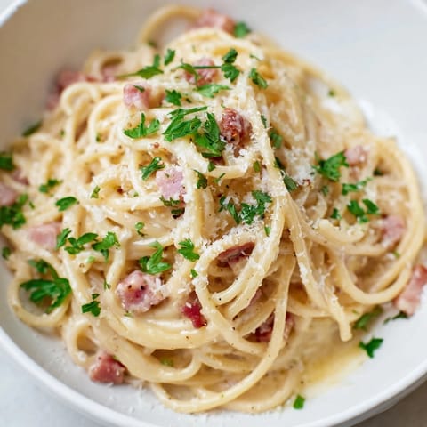 Imagine a bowl of Ramen Carbonara Hack, perfectly mixed with bits of bacon and fresh parsley.
