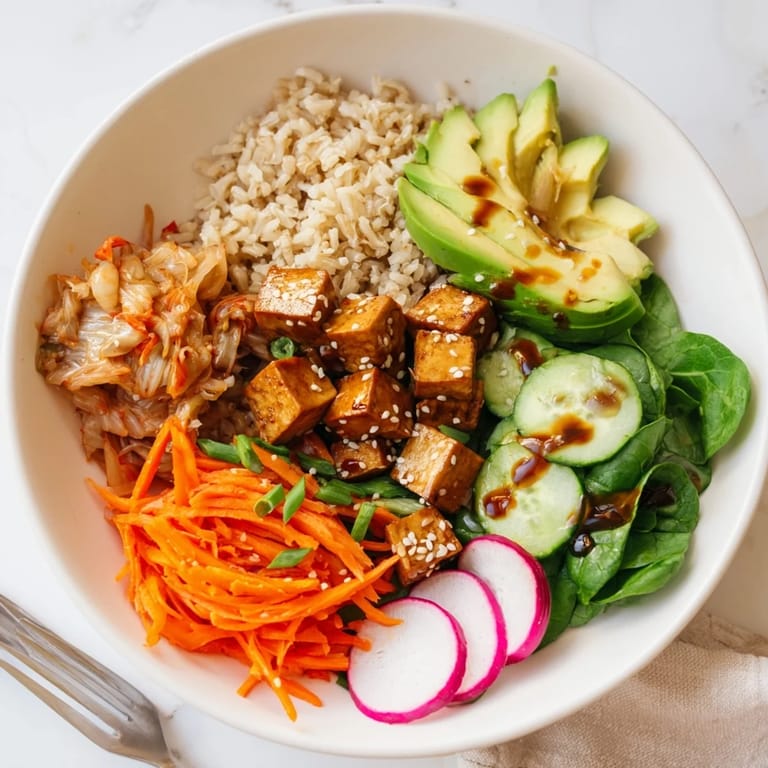 Vibrant bowl featuring crispy radishes, kimchi, and a zesty sesame dressing.