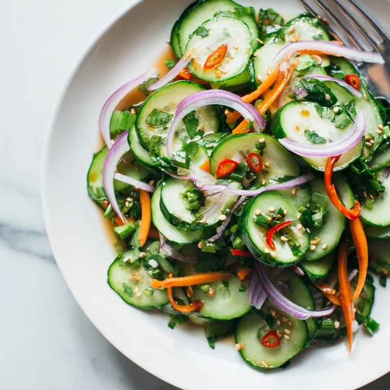 Savory cucumber salad remix tossed in Asian dressing, perfect for light appetizers.  