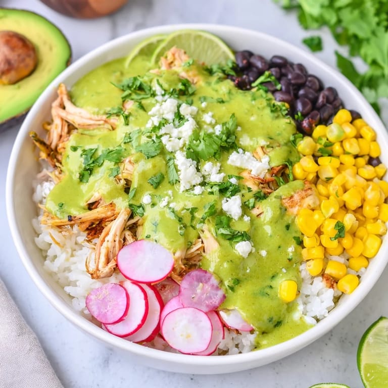 Warm Green Enchiladas Rice Bowl packed with flavorful chicken, creamy avocado, and crunchy radishes, a delightful meal.