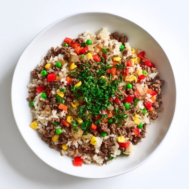 Enjoy a delicious plate of Ground Beef Skillet with Veggies & Rice, smelling of spices and perfectly cooked.
