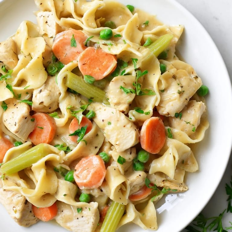Savory Creamy Chicken and Egg Noodles with herbs and vegetables, a home-cooked American meal.