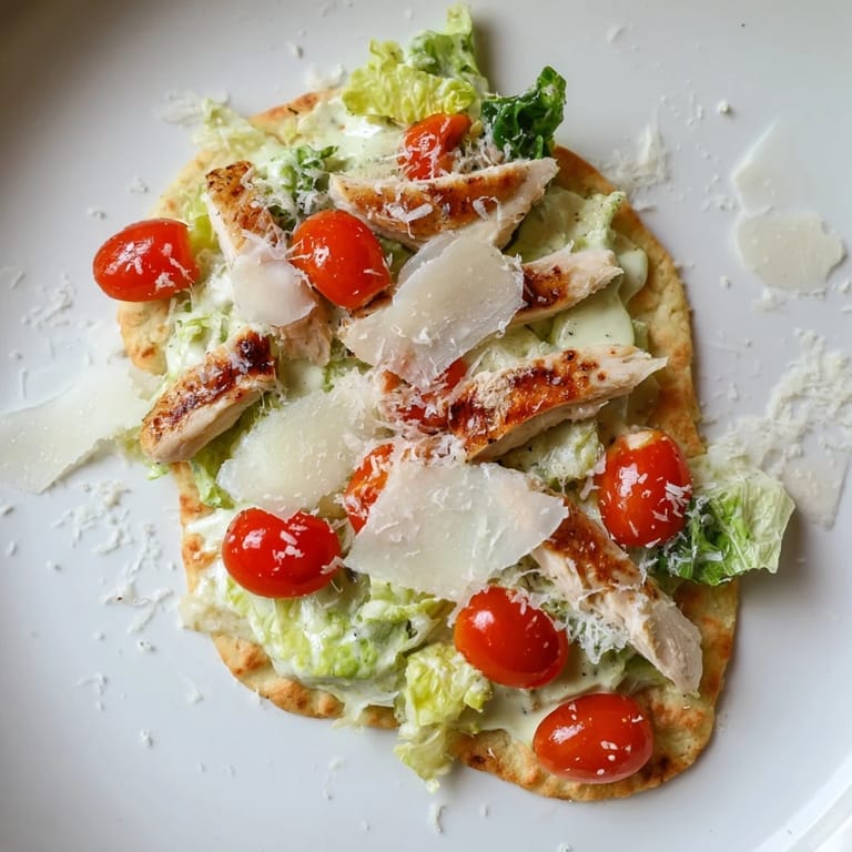 This delicious Caesar Chicken Flatbread showcases warm grilled chicken nestled on crisp romaine and melted Parmesan, perfect for a quick lunch or dinner.